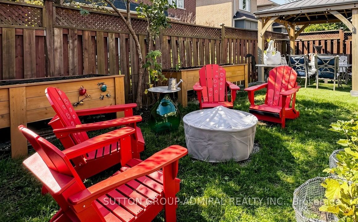 Muskoka chairs around the fire bowl in the gardens