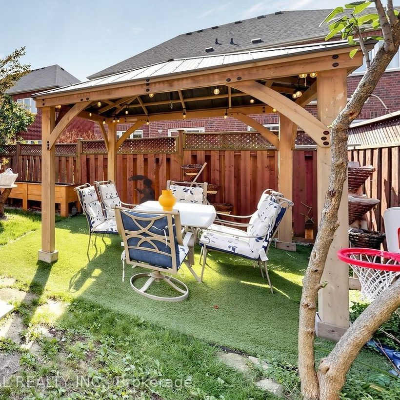 Cedar gazebo with string lights and dining set